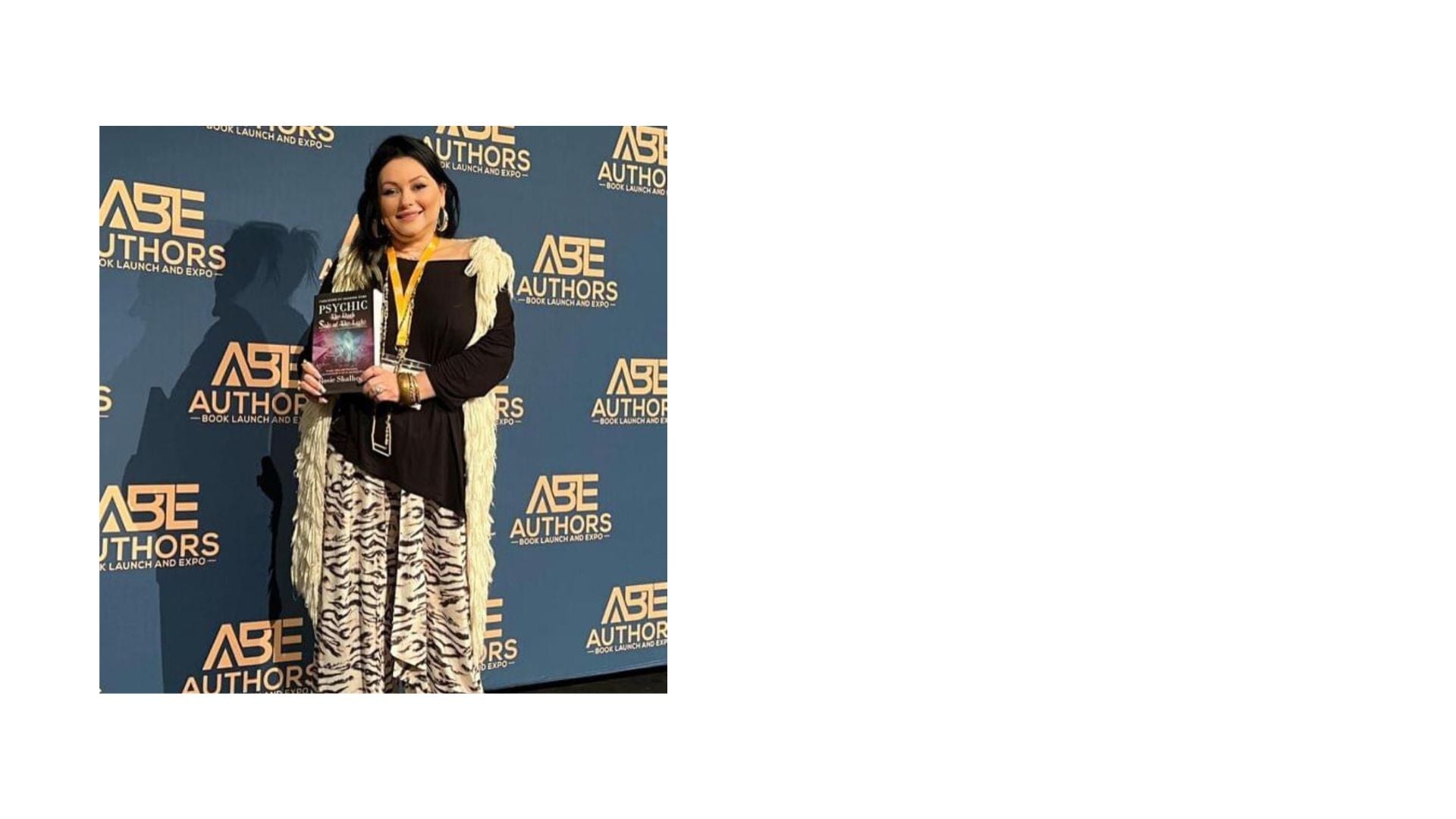 image of rosie shalhoub holding her best selling book THE DARK SIDE OF THE LIGHT after winning an award